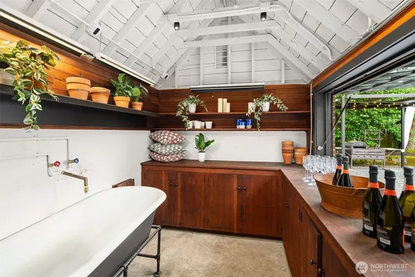 a kitchen with a sink and a stove next to a window