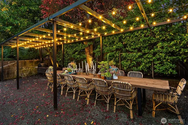 a view of a patio with a table and chairs under an umbrella
