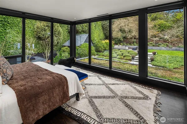 a bed sitting in a bedroom next to a large window