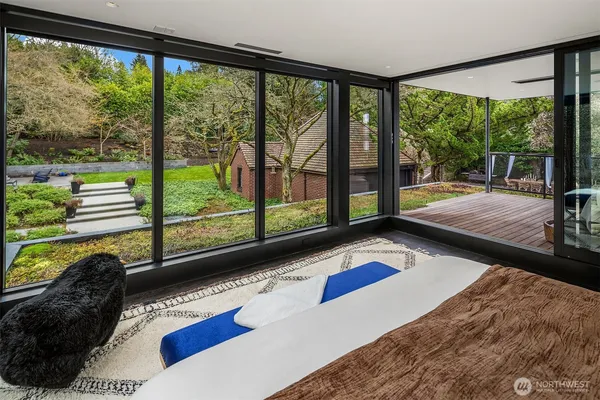 a bedroom with furniture and a large window