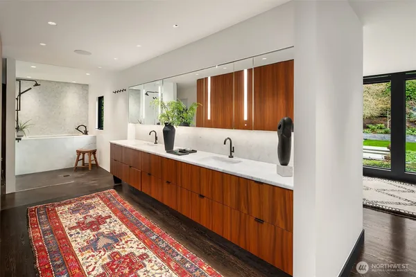 a large bathroom with a double vanity sink a mirror and a bathtub