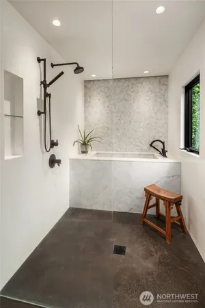 a bathroom with a bathtub and a shower