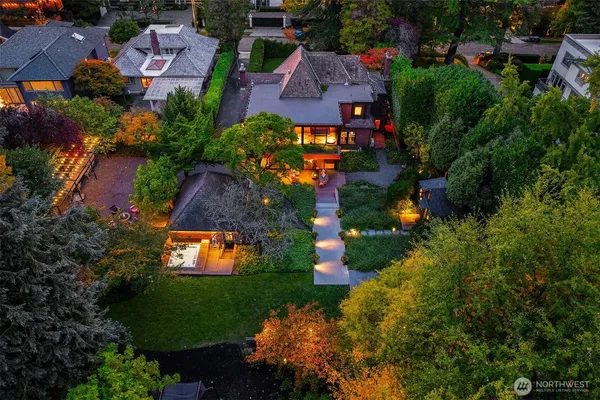 an aerial view of a house with a yard and lake view