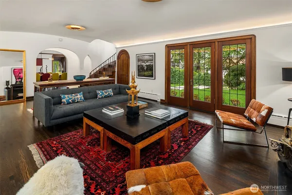 a living room with furniture and a floor to ceiling window