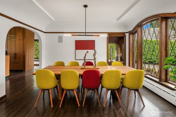 a dining room with furniture and wooden floor