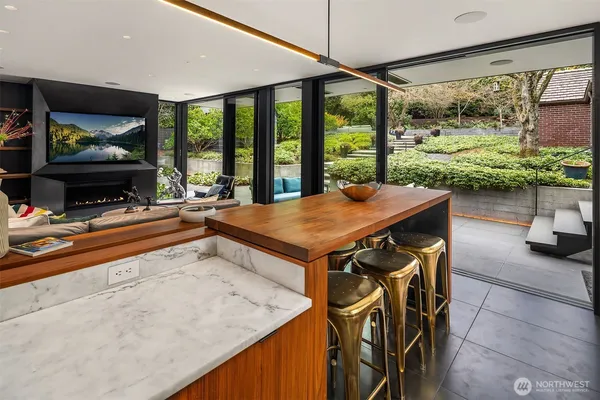 a view of a dining room with furniture large windows and wooden floor