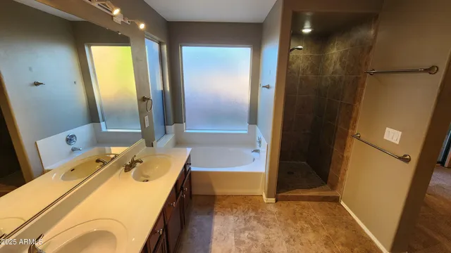 a bathroom with a tub sink and mirror