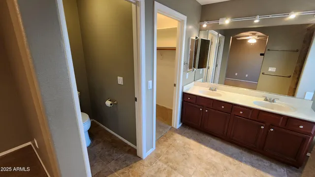 a spacious bathroom with a double vanity sink and a mirror