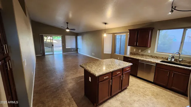 a kitchen with a stove sink and cabinets