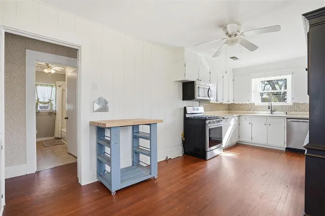 a view of kitchen with sink and wooden floor