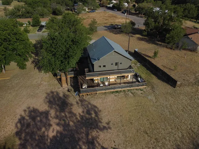 an aerial view of a house with a yard basket ball court and outdoor seating