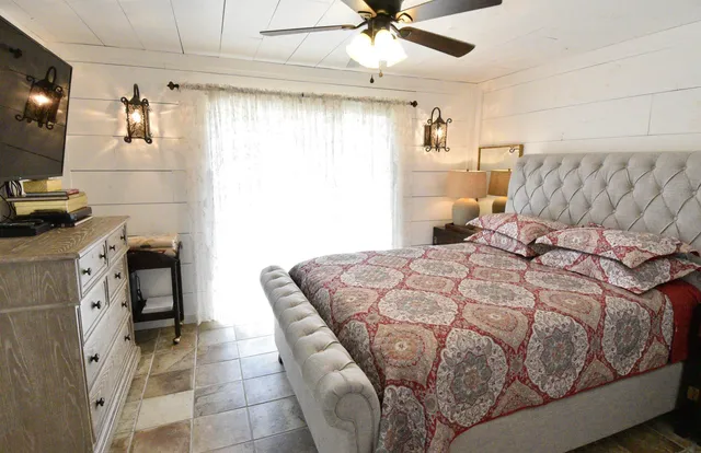 a bedroom with a bed and a flat screen tv