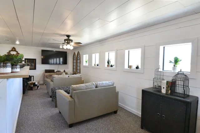 a living room with furniture and a chandelier