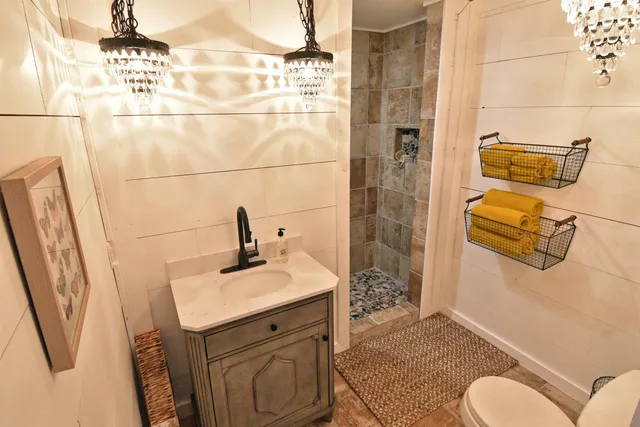 a bathroom with a sink toilet and shower