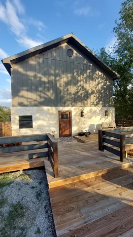 a view of backyard with wooden floor and outdoor seating