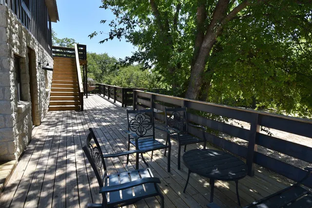 a view of balcony with wooden floor and outdoor seating