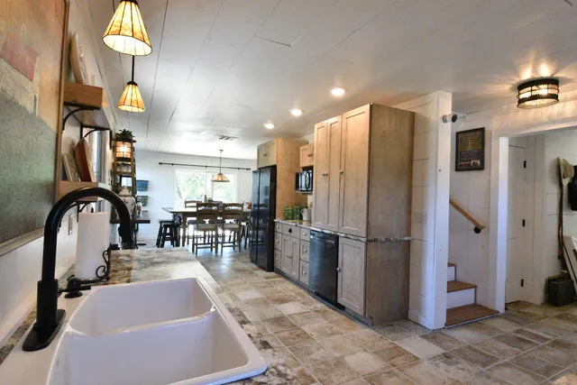 a kitchen with refrigerator and mirror