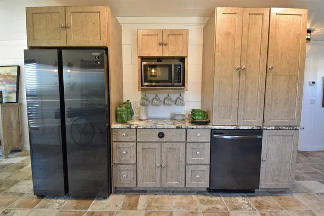 a bathroom with a granite countertop sink a mirror and a shower