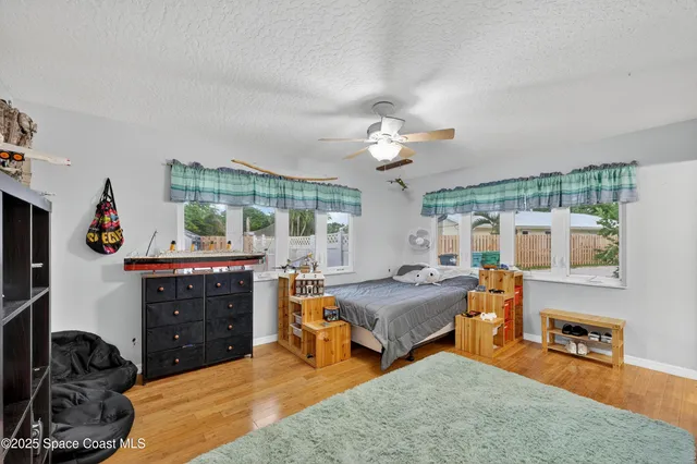 a bedroom with furniture and a chandelier