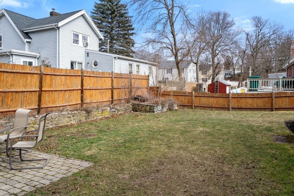 68 Sutcliffe Road Lynn, MA 01904 - Photo 14 of 15 a backyard of a house with wooden fence