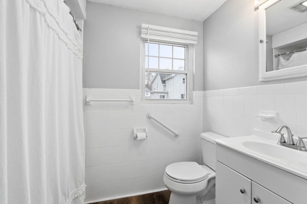 68 Sutcliffe Road Lynn, MA 01904 - Photo 10 of 15 a bathroom with a toilet a sink and a window