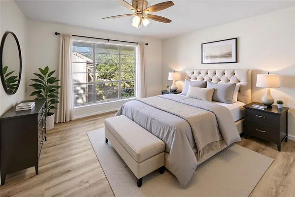 a bedroom with a large bed and a window