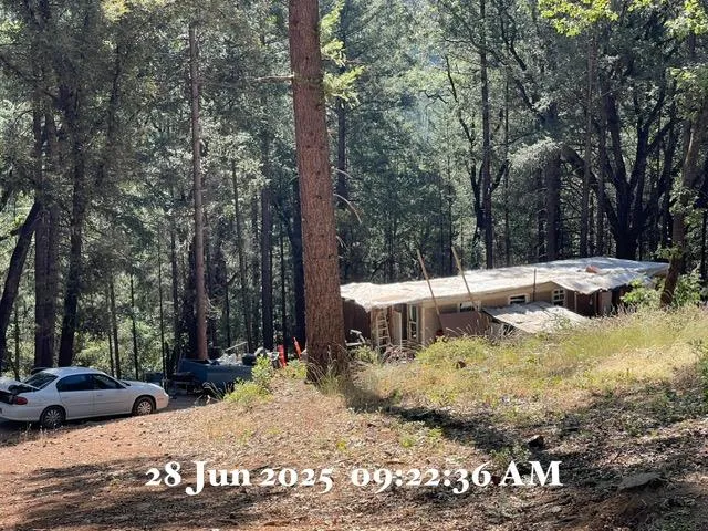 a view of a house with a yard covered in snow