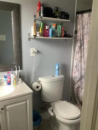 a bathroom with a toilet sink and a shower