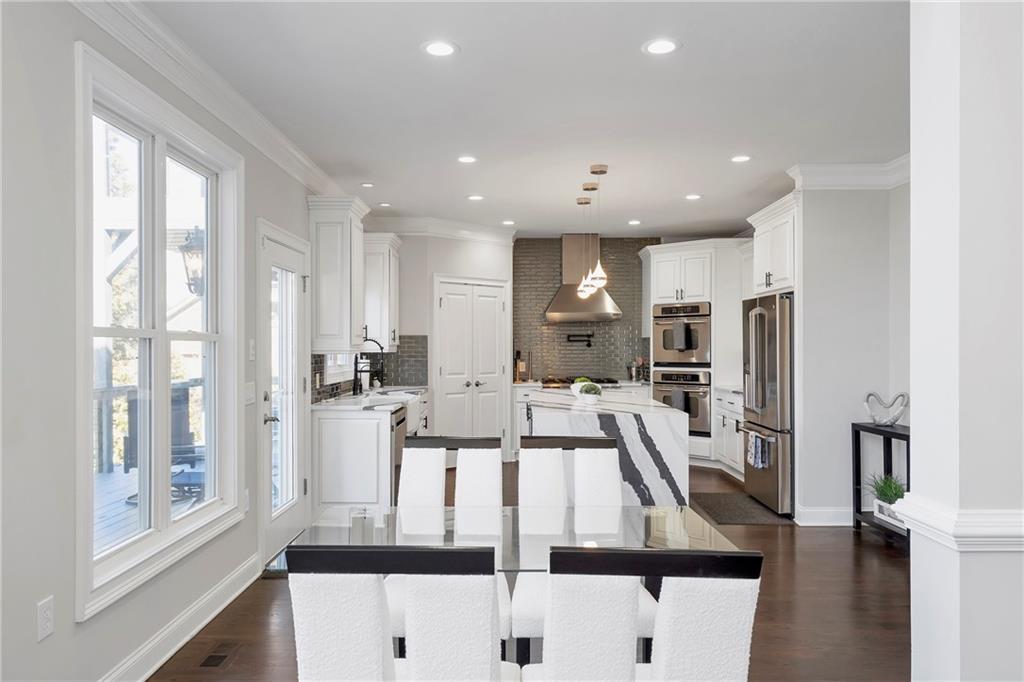 5755 Riley Road Cumming, GA 30028 - Photo 14 of 77 a kitchen with stainless steel appliances kitchen island granite countertop a refrigerator and microwave