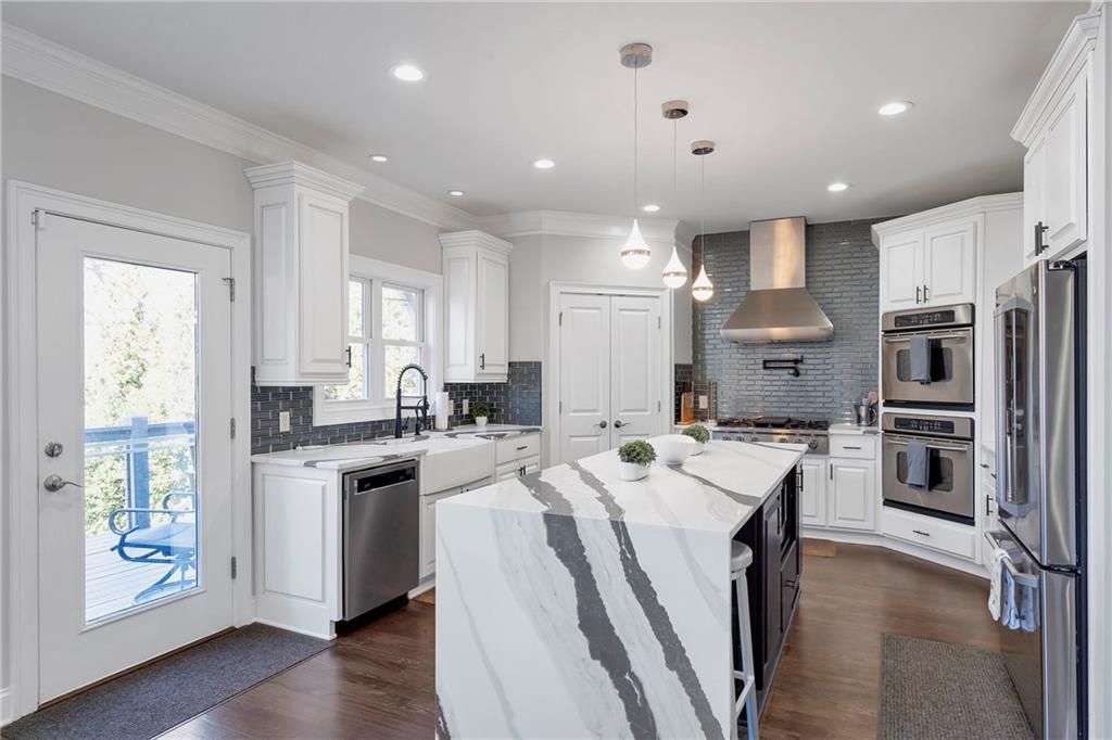 5755 Riley Road Cumming, GA 30028 - Photo 15 of 77 a kitchen that has a lot of cabinets a sink and appliances in it