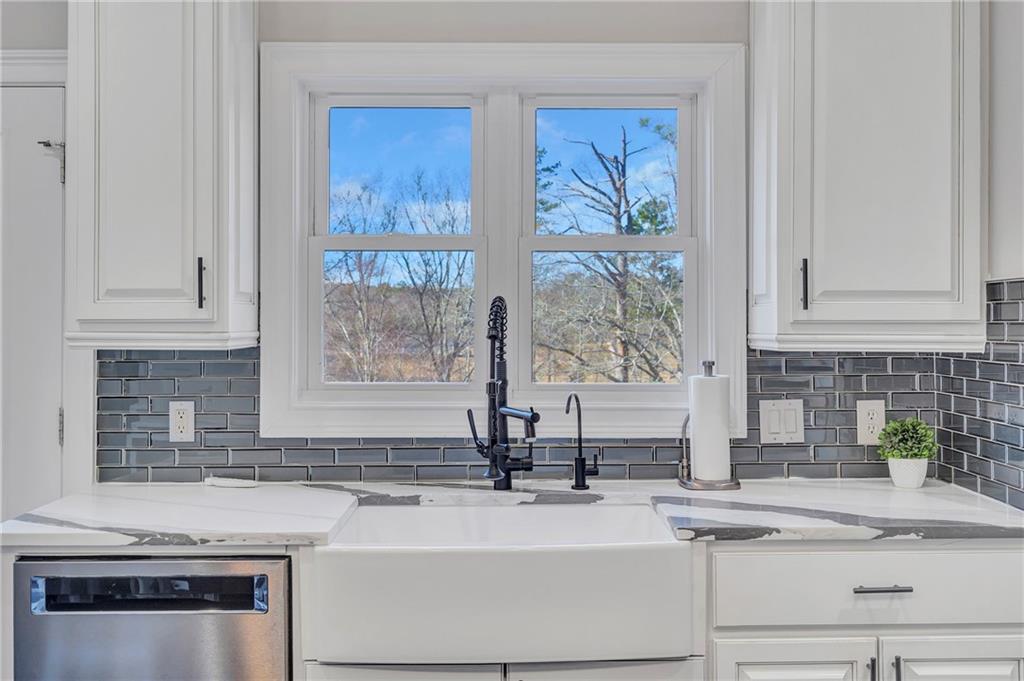 5755 Riley Road Cumming, GA 30028 - Photo 20 of 77 a kitchen with stainless steel appliances granite countertop white cabinets and a granite counter tops