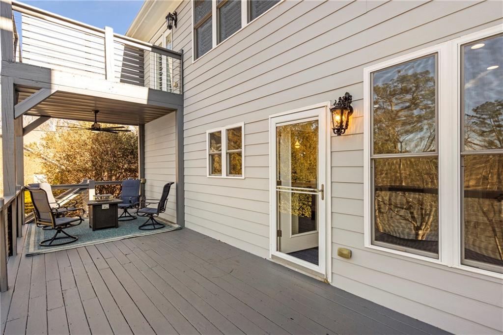 5755 Riley Road Cumming, GA 30028 - Photo 24 of 77 a view of a patio with table and chairs and wooden floor