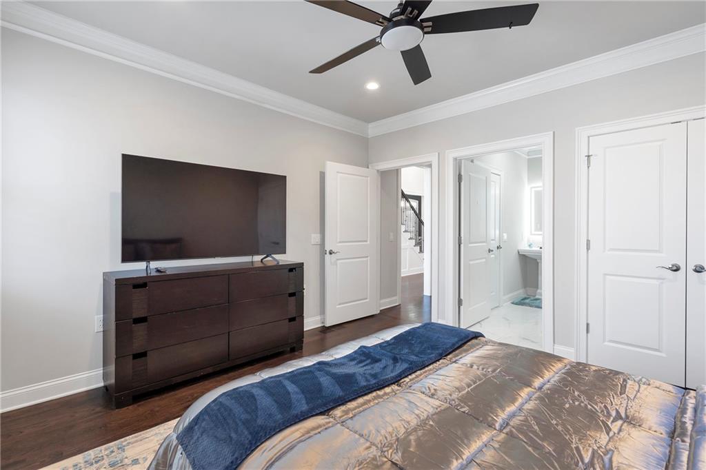 5755 Riley Road Cumming, GA 30028 - Photo 26 of 77 a bedroom with a bed and a flat screen tv