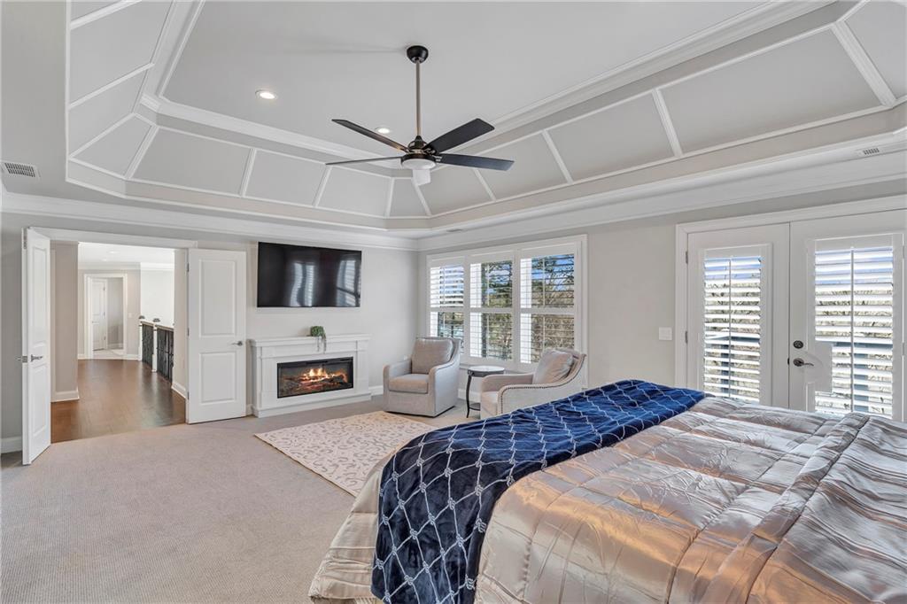 5755 Riley Road Cumming, GA 30028 - Photo 31 of 77 a bedroom with a large bed a flat tv screen and dresser