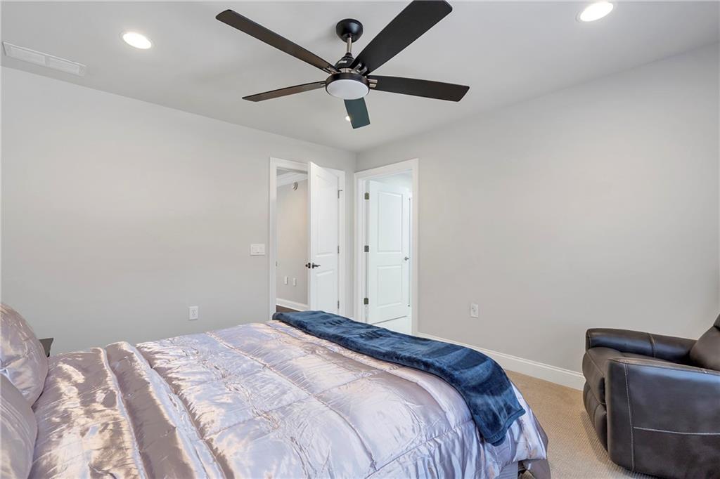 5755 Riley Road Cumming, GA 30028 - Photo 42 of 77 a bedroom with bed and a ceiling fan