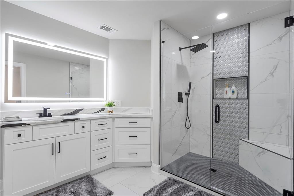 5755 Riley Road Cumming, GA 30028 - Photo 43 of 77 a bathroom with a shower sink and mirror