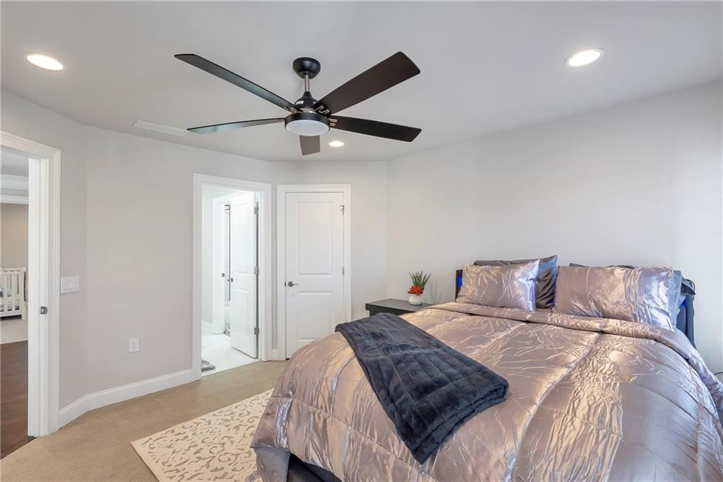 5755 Riley Road Cumming, GA 30028 - Photo 46 of 77 a bed room with a bed and a ceiling fan