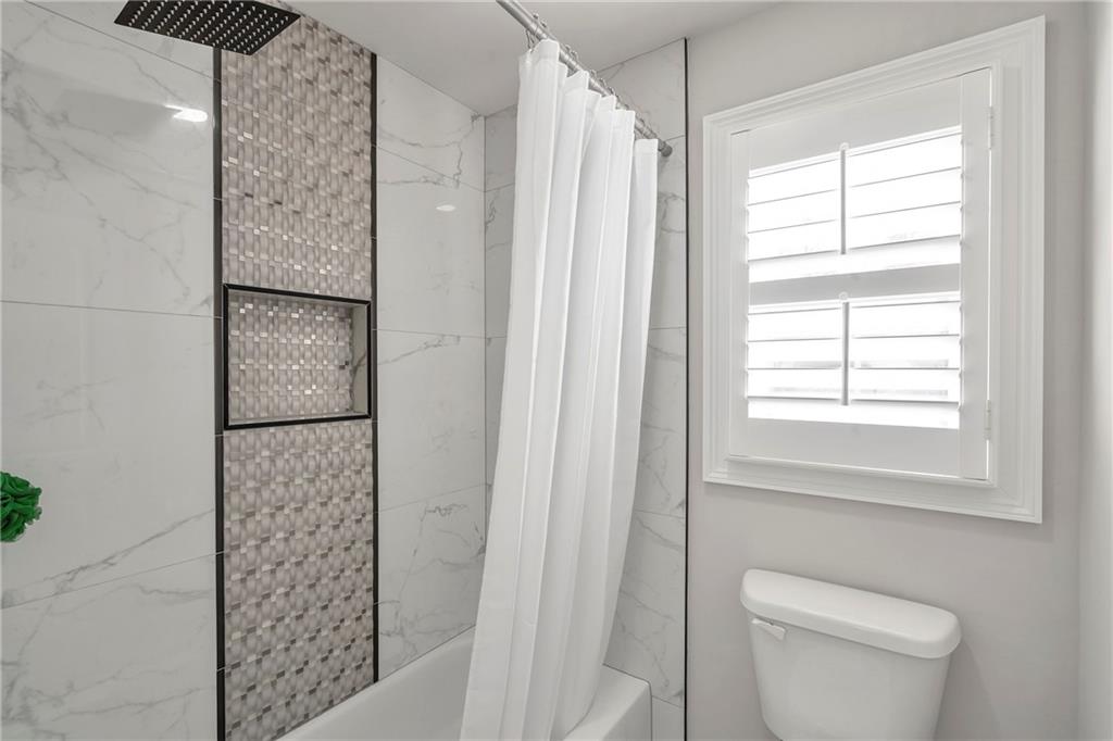 5755 Riley Road Cumming, GA 30028 - Photo 48 of 77 a bathroom with a shower and a toilet