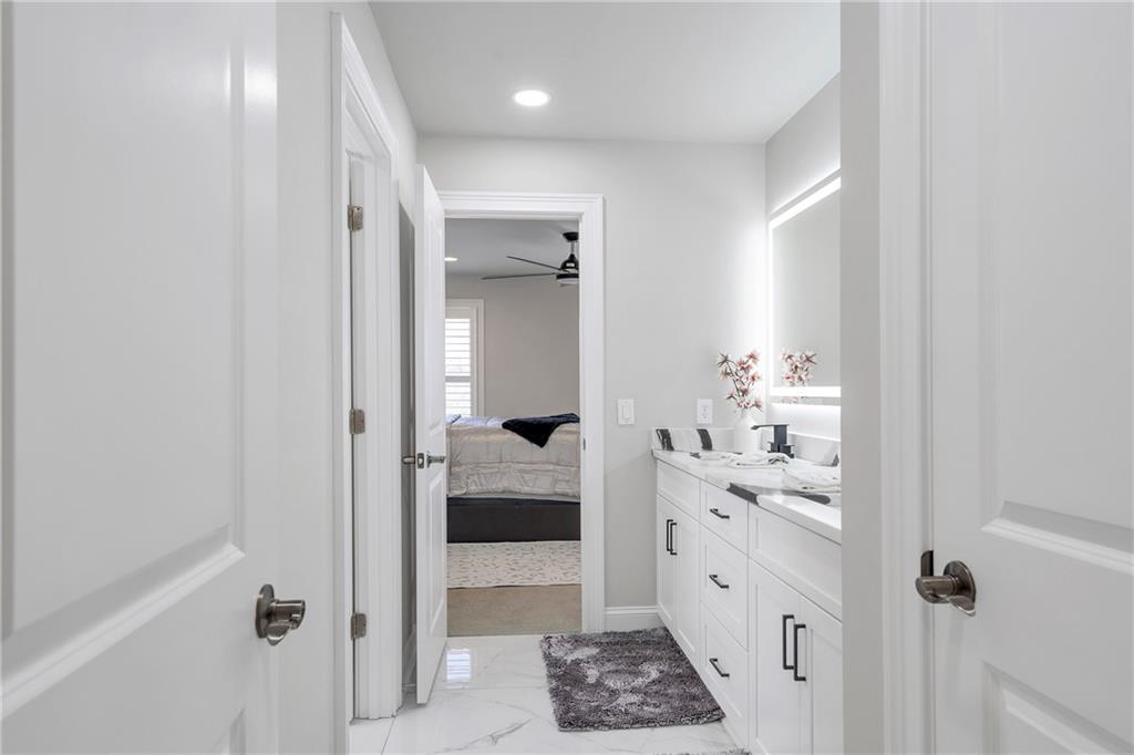 5755 Riley Road Cumming, GA 30028 - Photo 49 of 77 a bathroom with a sink and mirror with shower