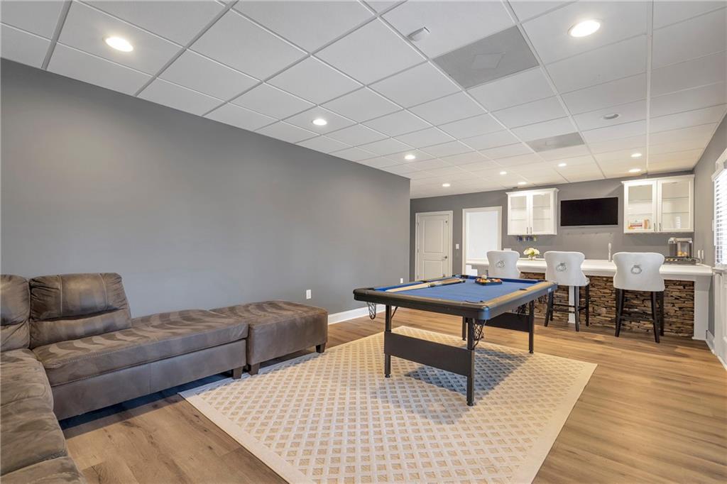 5755 Riley Road Cumming, GA 30028 - Photo 55 of 77 a living room with furniture a table and kitchen view
