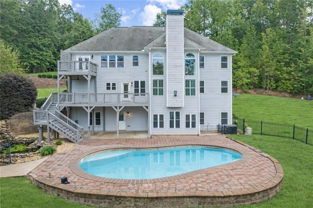 5755 Riley Road Cumming, GA 30028 - Photo 62 of 77 a view of a house with a swimming pool