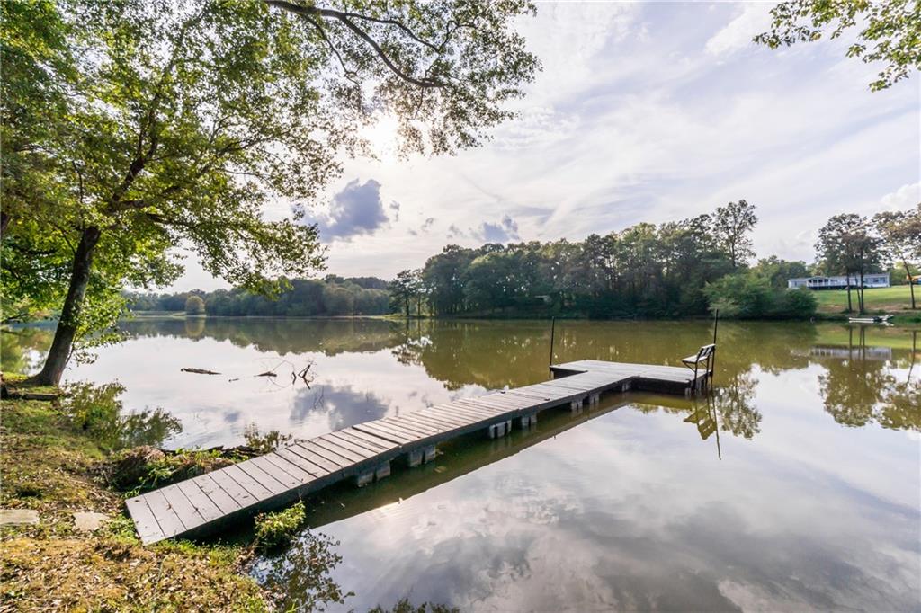 5755 Riley Road Cumming, GA 30028 - Photo 68 of 77 a view of a lake with houses in the back
