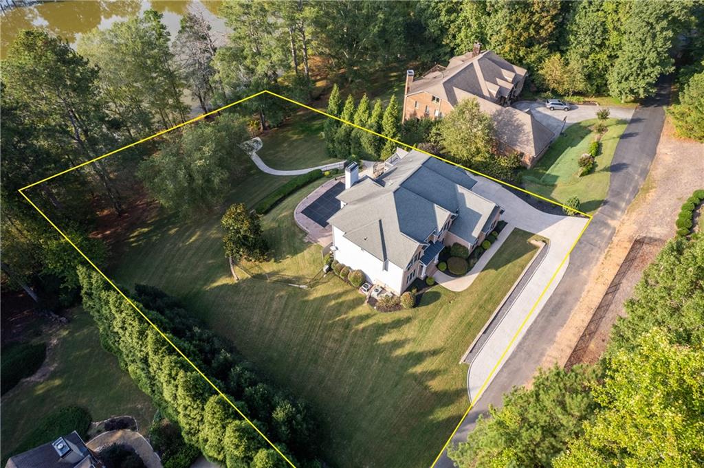 5755 Riley Road Cumming, GA 30028 - Photo 75 of 77 an aerial view of a house with a garden and swimming pool