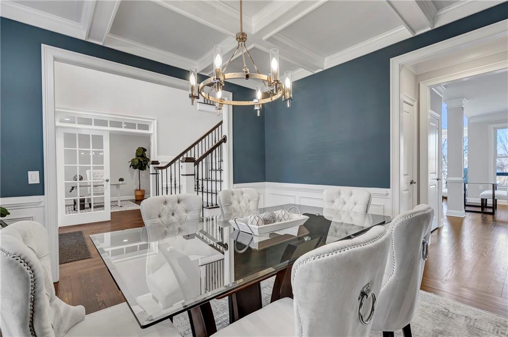 5755 Riley Road Cumming, GA 30028 - Photo 10 of 77 a view of a dining room with furniture a chandelier and wooden floor