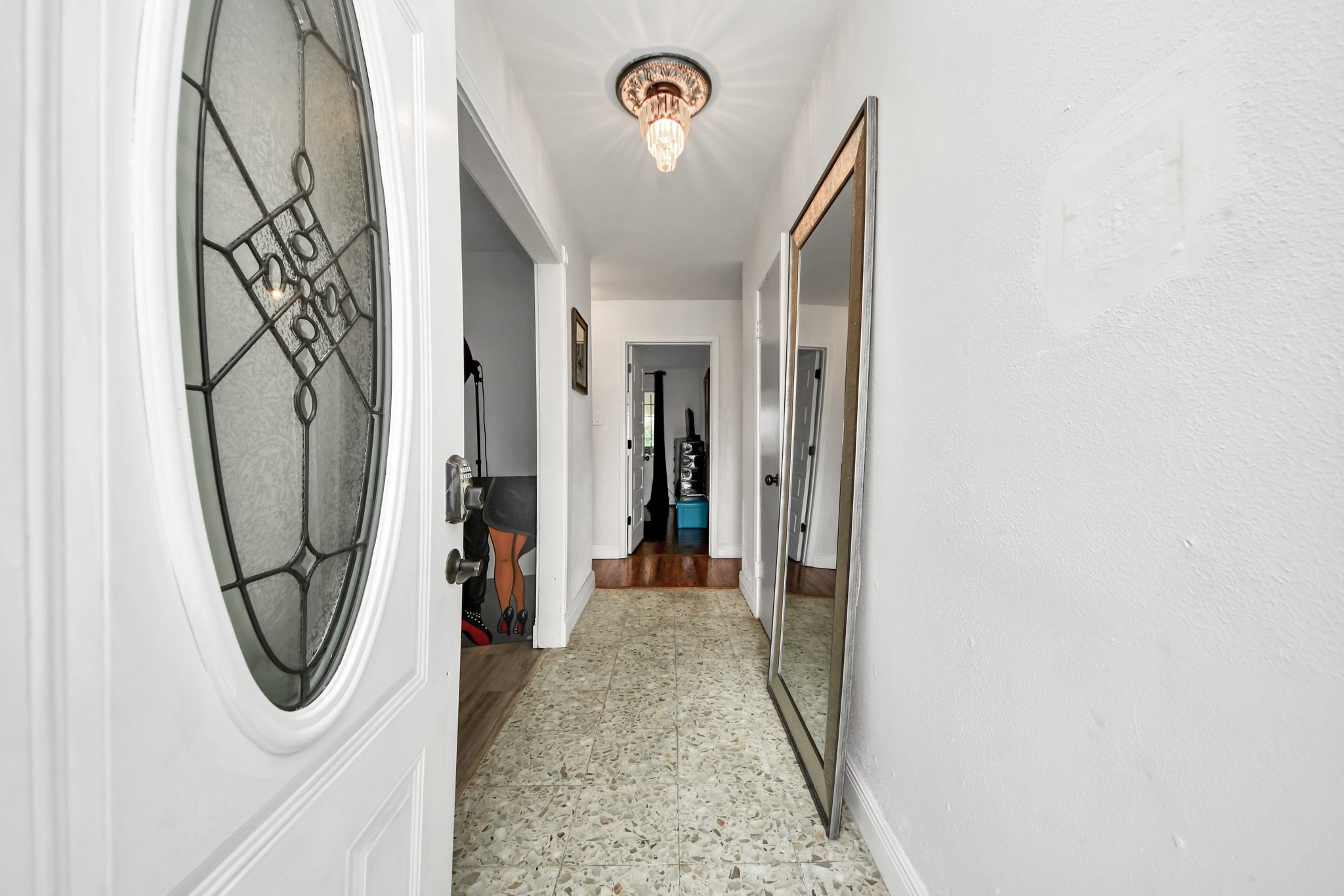 3901 Jeanetta Street Houston, TX 77063 - Photo 8 of 41 Welcoming entryway featuring decorative glass front door, classic chandelier-style lighting and inviting hallway to formal living and dining rooms.