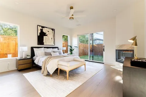 a spacious bedroom with a bed and a couch