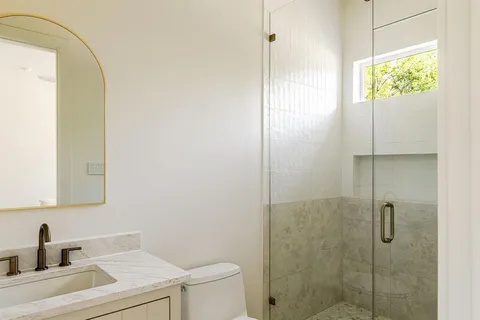 a bathroom with a sink toilet and shower