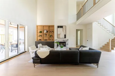 a bedroom with furniture and large windows