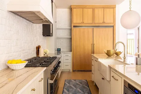 a kitchen with a sink appliances and a cabinets