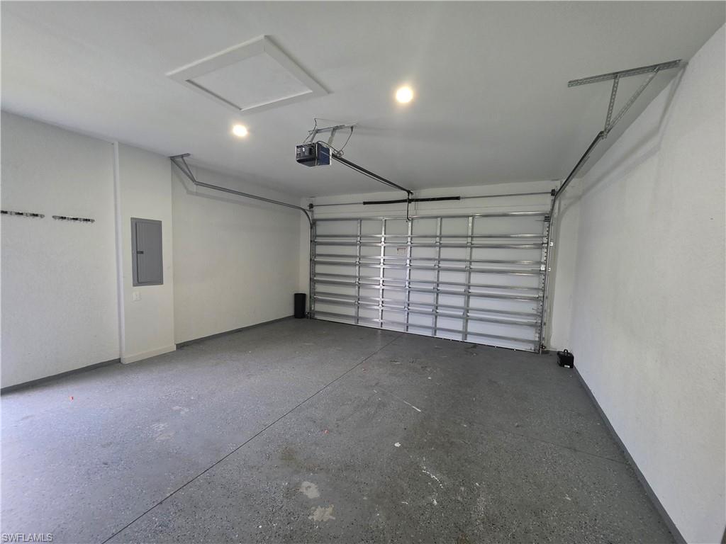331 Nelson Road North Cape Coral, FL 33993 - Photo 9 of 29 Dedicated utility space featuring marble-look tile flooring, white walls, and a recessed ceiling light